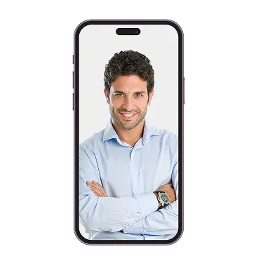 An older man in a hat holding a small white dog inside a phone screen.